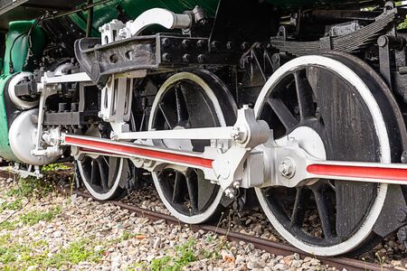 the old locomotive the big iron wheels of the steam train stands on the tracksの写真素材