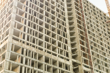 high cement foundation of a multi-storey building on the background of the sky close-up