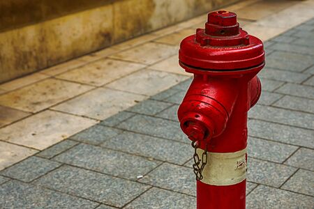 fire hydrant red white protection of the city on a background of gray tiles urban designの写真素材