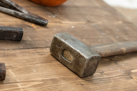 old hammer sledge hammer tool for building rests on wooden planks