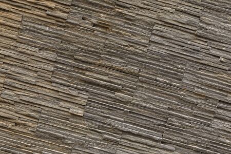 stone slate wall dark gray sloping stripes solid ribbed patternの写真素材