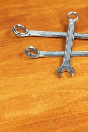 three wrenches hand tools for auto repair on a wooden background