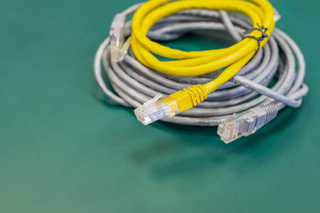 pair of lan wires with rj45 connector gray and yellow, engineering background