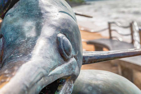 Krabi Thailand July 2018. Bronze statue on Ao Nang beach catching sword fish close up against the background of the oceanのeditorial素材