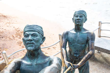Krabi Thailand, July 2018. Statue on ao nang beach catching marlin fishermen part against the oceanのeditorial素材