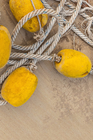 natural canvas rope old and weathered with strung yellow buoys