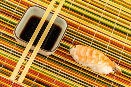 sushi with fresh and tasty salmon a traditional dish of japanese food stands on a bamboo backgroundの写真素材