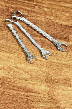 tool iron wrench set different size lies on a wooden background