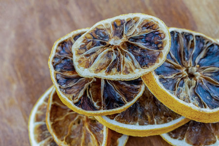 dried orange rings piled in a stack close-up on a wooden background