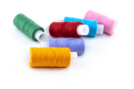 assortment of cotton skeins of orange, red and green material for needlework