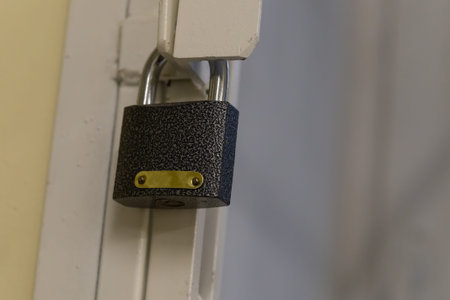 iron lock on a background of a lattice with copy space close-up