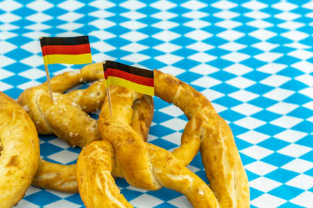 set culinary fresh baked pretzel with germany flag close upの写真素材