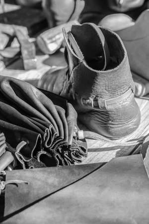 leather goods boot and wallet leather close up black and white designの写真素材