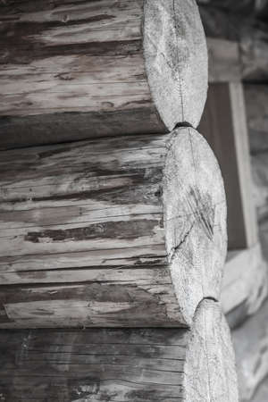 logs stacked in a row vertically house wall toned designの写真素材
