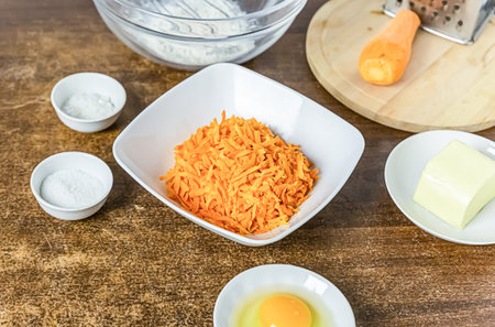 recipe for making carrot cake grated root vegetable, eggs and butterの写真素材