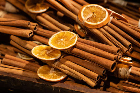 cinnamon sticks bunch and orange ring dried christmas decorの写真素材