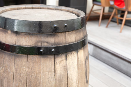 oak barrels light beige with a black hoop vertically on the background of a street cafe