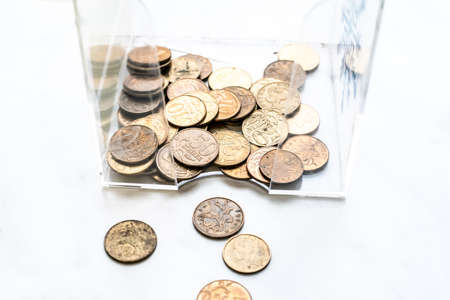 scattering of coins on a white background close-up, piggy bank changeの写真素材