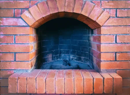 red stone brick fireplace outdoor firebox black burntの写真素材