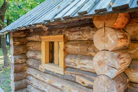 wooden houses made of logs traditional with a small window on the wall angle viewの写真素材