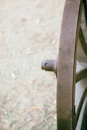 iron wheel of a van old and weathered close up on the background of the earthの写真素材