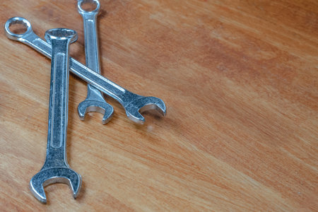 three wrenches on wooden background master repair tool