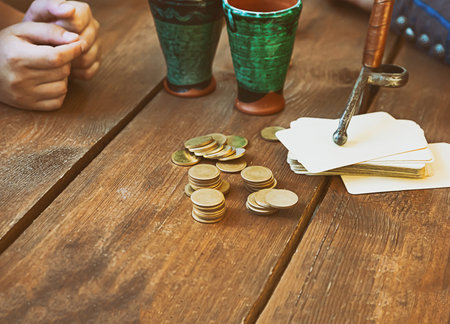card game and stack of coins bet, cards on the background of the glass, casino of the middle ages