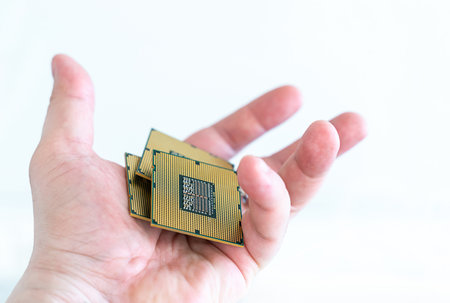 CPU unit in open hands of a man on an isolated white backgroundの写真素材