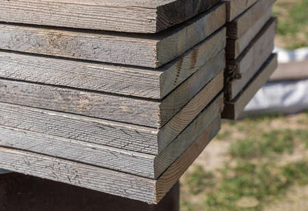 stack of wooden planks for floor dark brown close-up side viewの写真素材