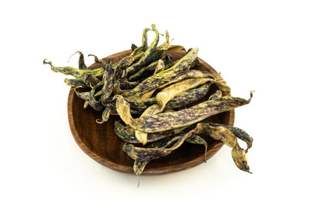 green bean pods in wooden bowl on isolated backgroundの写真素材