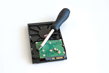 screwdriver on hdd board background on isolated background, computer repairの写真素材