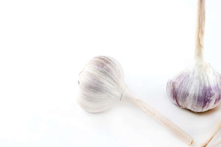 several heads of garlic on a white background with copy spaceの写真素材