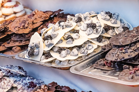 tray of sweets handmade chocolates with prunes and berries assortmentの写真素材