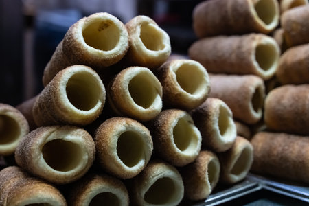 stack of freshly baked trdelnik close-up, traditional Prague dessertの写真素材