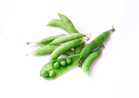 green peas open and closed pod with grains on isolated backgroundの写真素材