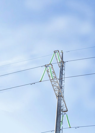 electric pole mast with wires on sky background