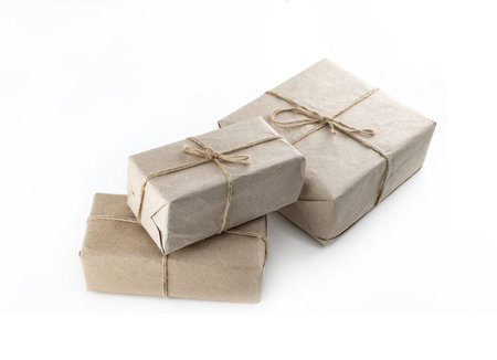 giftbox in kraft brown paper three boxes with a gift on an isolated white background
