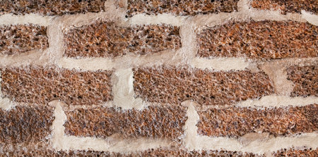 stone wall made of bricks with wide gray joints, stripes close-up