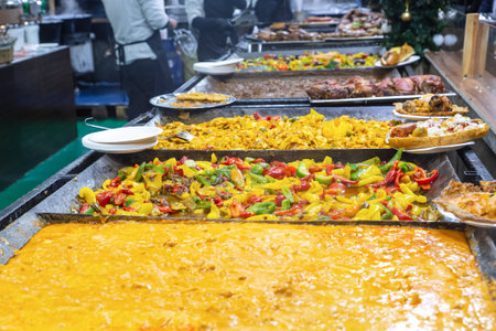 assorted dishes of European street food, curry, ratatouille and grilled meatsの写真素材