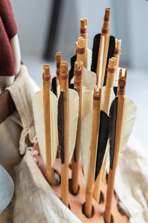 wooden bow arrows with white and black plumage close upの写真素材