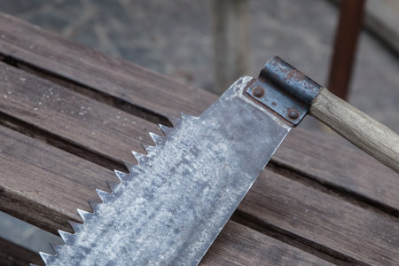 hand saw close-up against the background of boards, a saw with large teethの写真素材