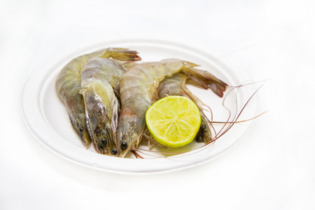 fresh big shrimp with lemon on isolated background, raw seafoodの写真素材