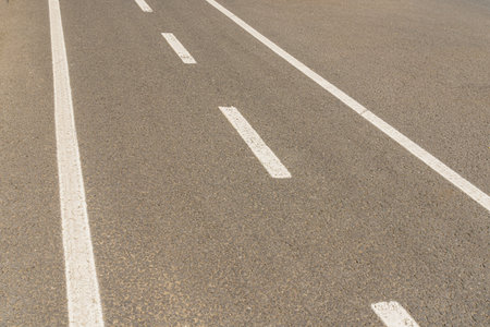 markings on an asphalt road, white lines on a gray background