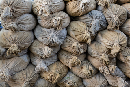 stack of sandbags protective wall in bad weather, flood backgroundの写真素材
