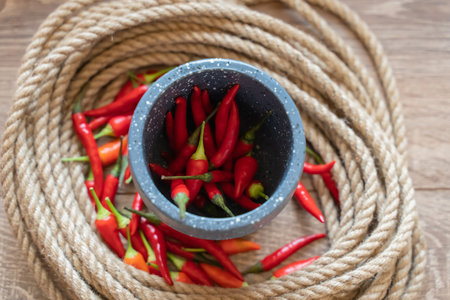 red chili pepper in a mortar, fresh vegetables on a selective backgroundの写真素材