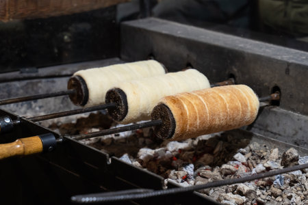 trdelnik is cooked on a fire on a special wooden dish, a traditional dessert of europeの写真素材