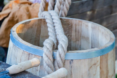 oak barrel with iron rings, light barrel and rope close-upの写真素材