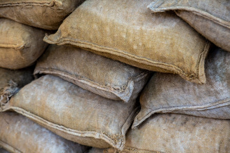 sandbag stacked closeup, protective wall against floods and bad weatherの写真素材