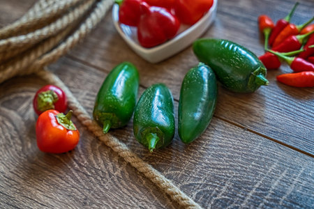 set of vegetables fresh hot jalapeno and chili peppers on wooden background selective focusの写真素材