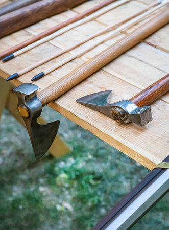 viking ax and arrows on wooden table close up selective focusの写真素材
